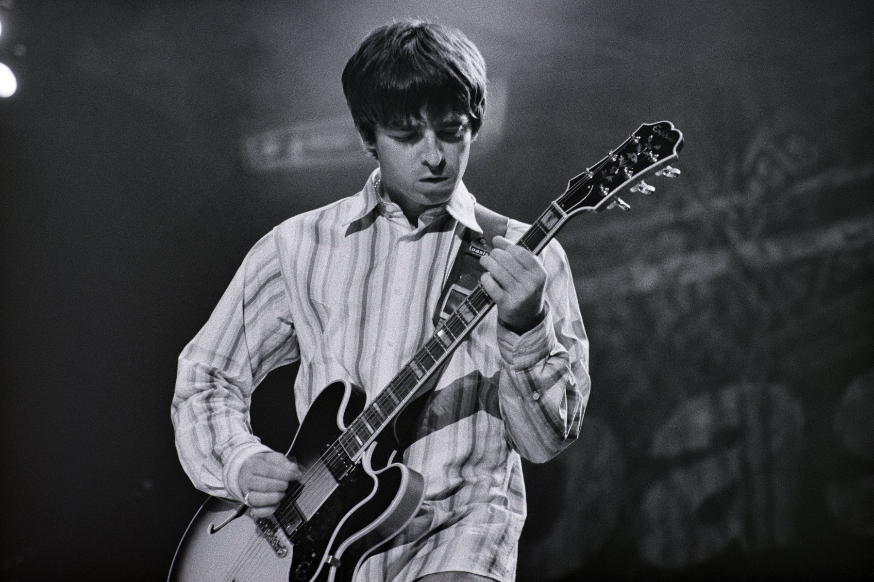 Noel Gallagher strumming Roll With It with one of his early Epiphone Sheraton II guitars.
