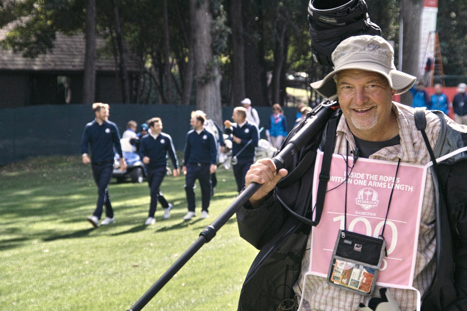 An Associated Press photographer shoulders his gear for the next photo opportunity.