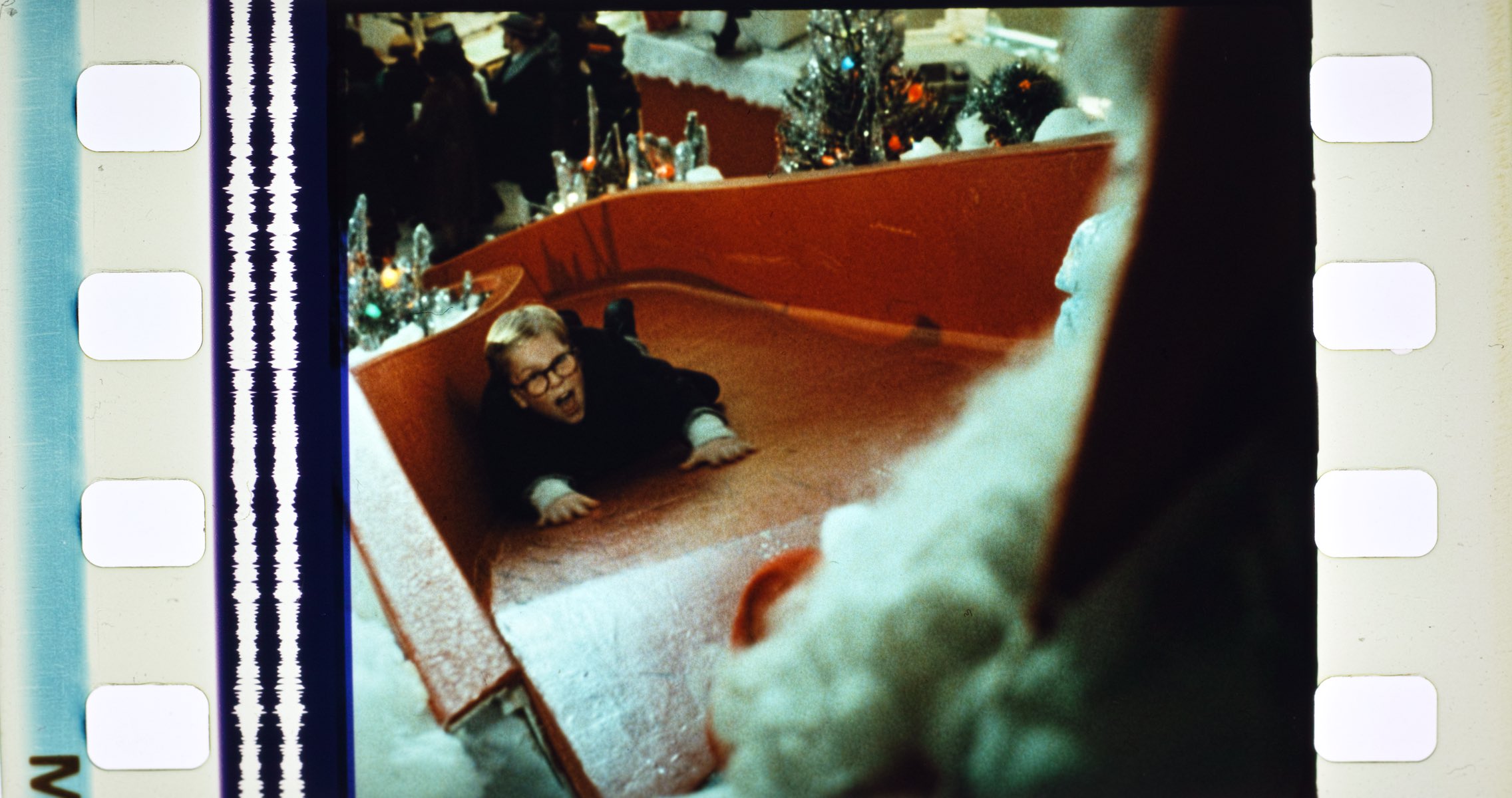 Ralphie gets the boot down Santa's slide.
